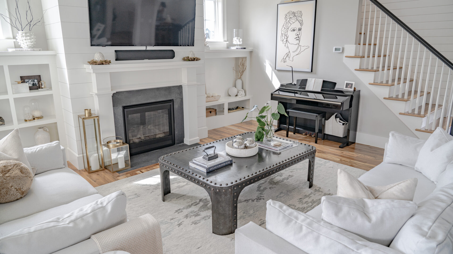 Living room in warm neutral tones with a linen sofa, brass floor lamp, and layered textiles.